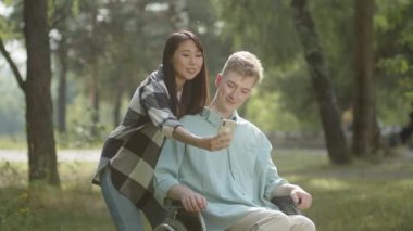 Güzel bir çift birlikte selfie çekiyor, gülümsüyor ve güzel bir havada parkta poz veriyorlar. Yüksek kalite 4k görüntü