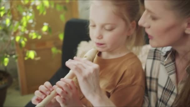 Mamá enseña a su hija a sostener la flauta — Vídeos de Stock