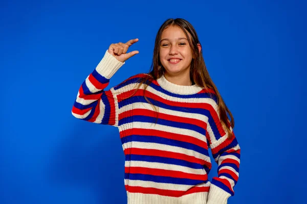 Joven chica hermosa sobre fondo aislado sonriente y seguro gesto con la mano haciendo signo de tamaño con los dedos mientras mira y la cámara. Concepto de medición — Foto de Stock