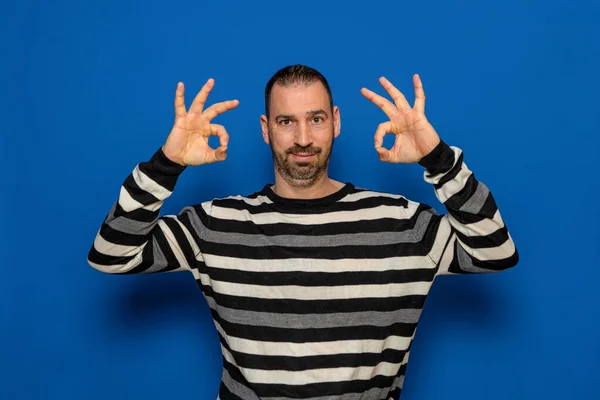 Hispanic Man Beard Dressed Striped Sweater Making Gesture Both Hands — Fotografia de Stock