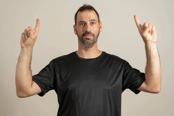 Portrait Happy Bearded Latin Man Pointing Fingers Copyspace Isolated Beige — Fotografia de Stock
