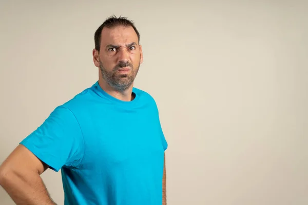 Serious Angry Bearded Man Blue Shirt Posing Isolated Beige Background — Fotografia de Stock