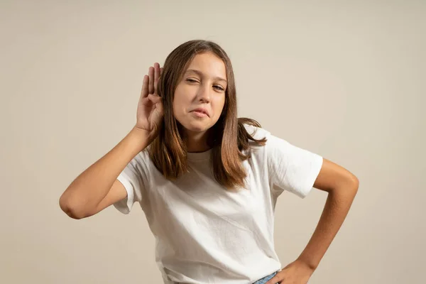Excited Teen Girl Holding Hand Next Ear Listening Something Beige — Stockfoto
