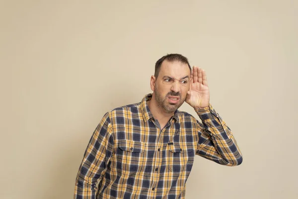 Listening Man Holds His Hand His Ear Beige Background Handsome — Fotografia de Stock