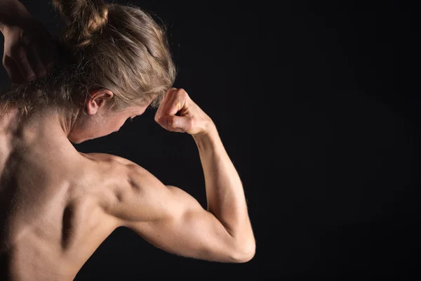 Vista trasera de la mujer en forma culturista joven posando con desnudo Fotos De Stock