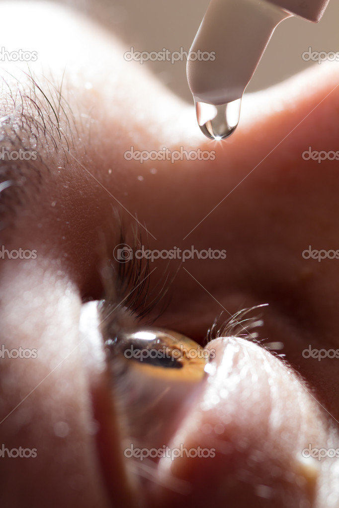 Close-up: man is applying eyedrops.
