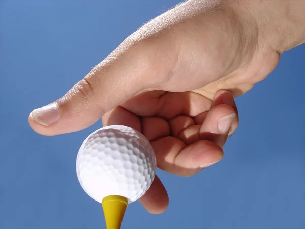 Hand und Golfball Stockbild