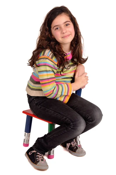 Little girl sitting in a chair — Stock Photo, Image