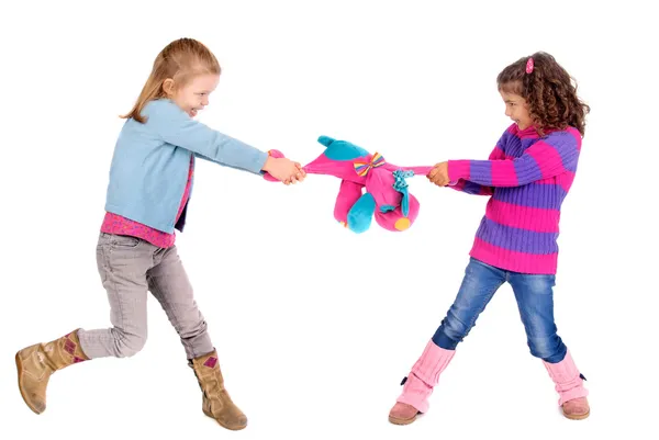 Two girls fighting over a toy — Stock Photo, Image