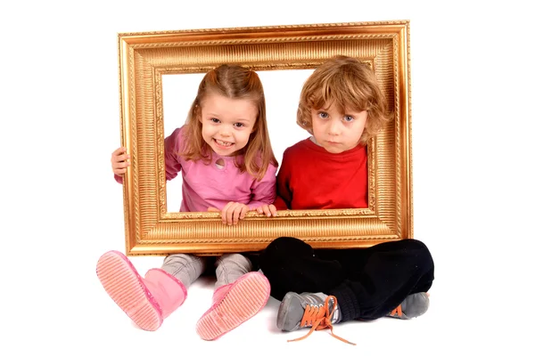 Boy and girl with frame — Stock Photo, Image