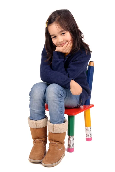 Little girl sitting on a chair — Stock Photo, Image