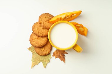 Beyaz arkaplanda süt ve balkabağı kurabiyeleri.