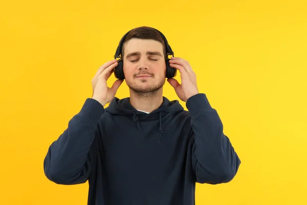 Young Man Hoodie Headphones Yellow Background — Stock Photo, Image