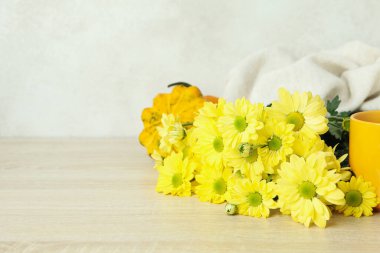 Ahşap masada kasımpatı olan sonbahar kompozisyonu.