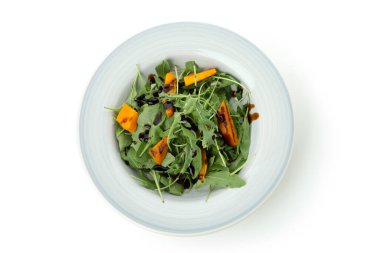 Beyaz arkaplanda kabak salatası olan tabak