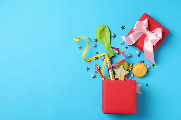 Gift box with Birthday accessories on blue background