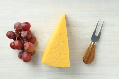 Beyaz ahşap arka planda sert peynirle yemek pişirme kavramı