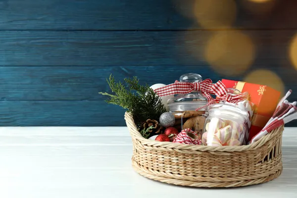 Concept of gift with Christmas basket on white wooden  table