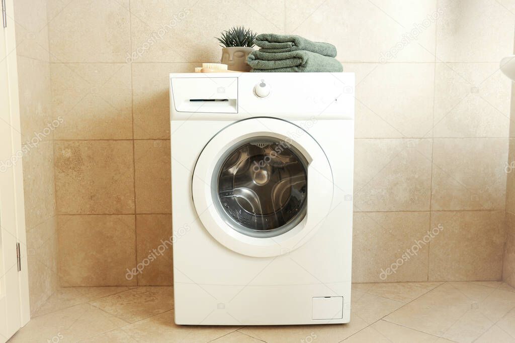 Concept of housework with washing machine in bathroom
