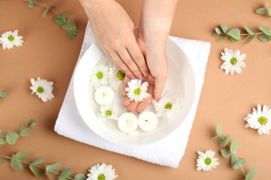 Çiçekli bej arka planda el bakımı kavramı