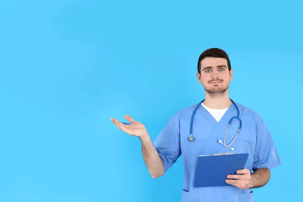 Male Nurse Clipboard Blue Background — Stock Photo, Image