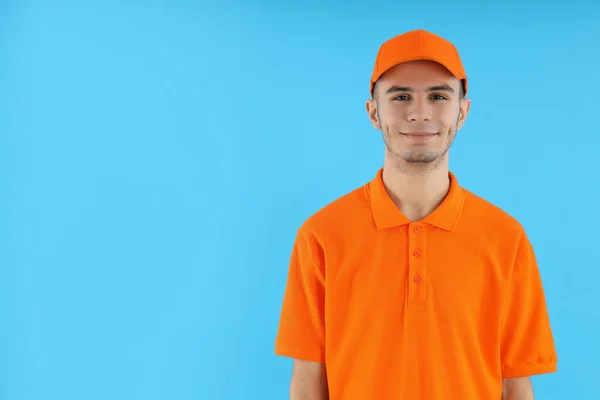 Attractive Young Delivery Man Blue Background — Stockfoto