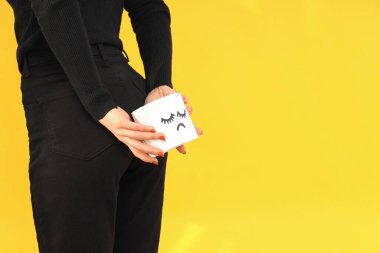 Woman holds toilet paper near her ass. Hemorrhoids concept