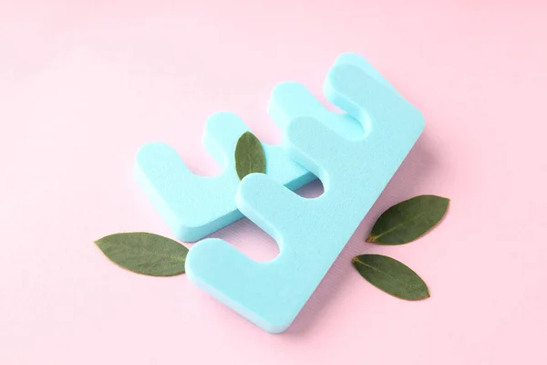 stock image Nail separators and leaves on pink background