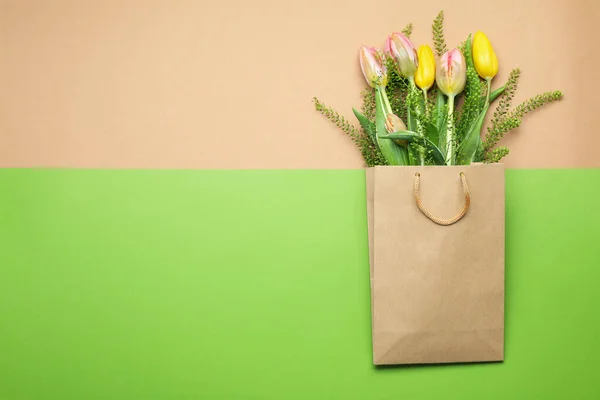 Paper bag with flowers on two tone background