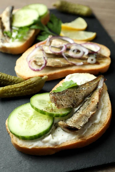 Tray with sandwiches with sprats, close up and selective focus