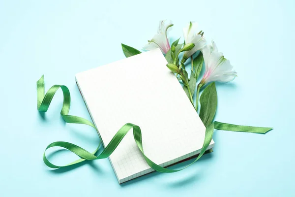 Lilies Green Ribbon Blank Notebook Blue Background — 스톡 사진