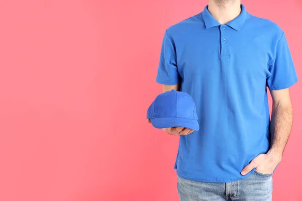Man Blank Blue Polo Holds Cap Pink Background — Stock Photo, Image