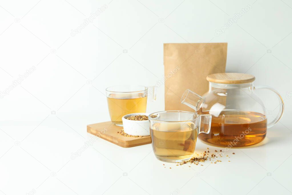 Concept of hot drink with buckwheat tea on white background