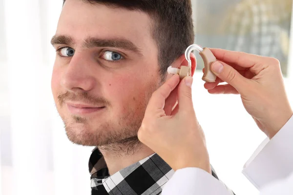 Doctor Installs Hearing Aid Young Man Ear Close — Stock Photo, Image