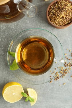 Gri desenli arka planda karabuğday çayı ile sıcak içecek kavramı