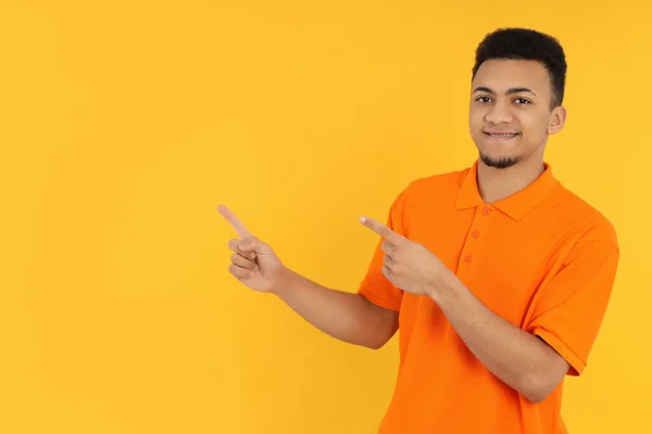 Young Man Orange Polo Yellow Background — Stock Photo, Image