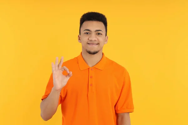 Молодой Человек Оранжевом Поло Жёлтом Фоне — стоковое фото