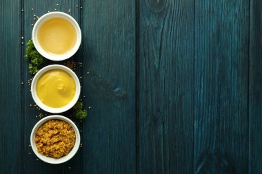 Ahşap masada soslu kaseler, metin için yer.