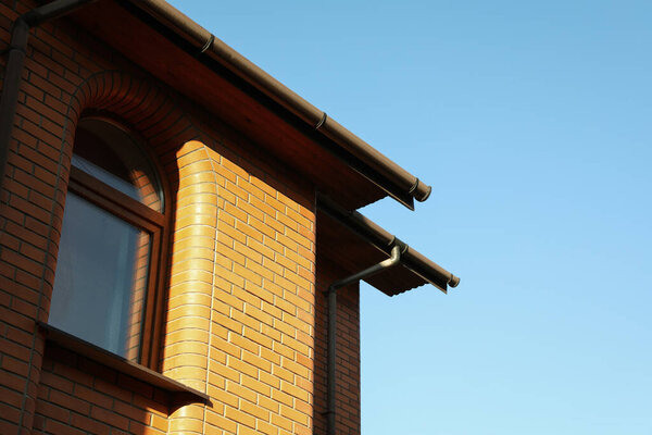 Brick house on a beautiful sunny day against blue sky