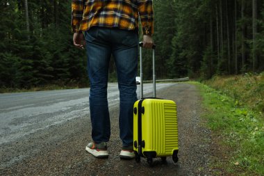 Macera ve turizm konsepti, otomobille seyahat eden genç adam.