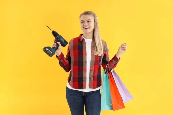 Young Woman Shop Bags Drill Yellow Background — стоковое фото