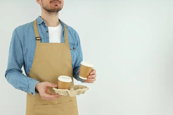 Concept of occupation, young waiter on light background