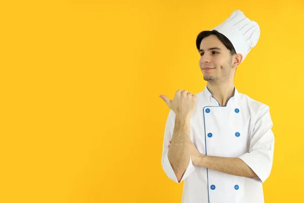 Concept Cooking Young Man Chef Yellow Background — Stok Foto