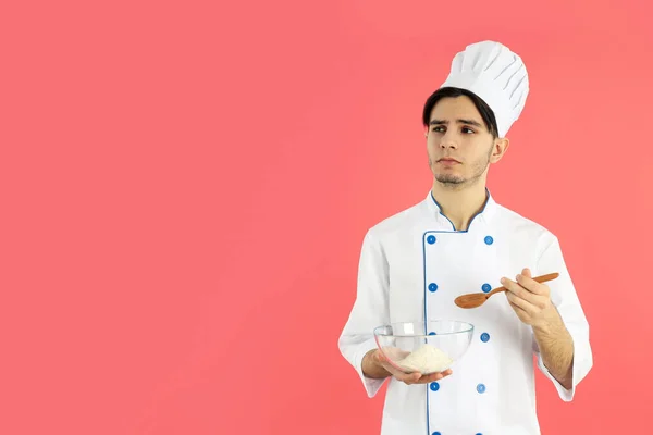 Concept Cooking Young Man Chef Pink Background — Stok fotoğraf