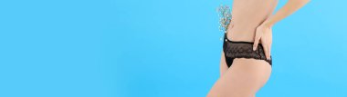 Young woman body in underwear on blue background