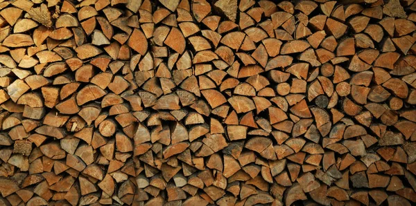 Dry chopped firewood logs in a pile