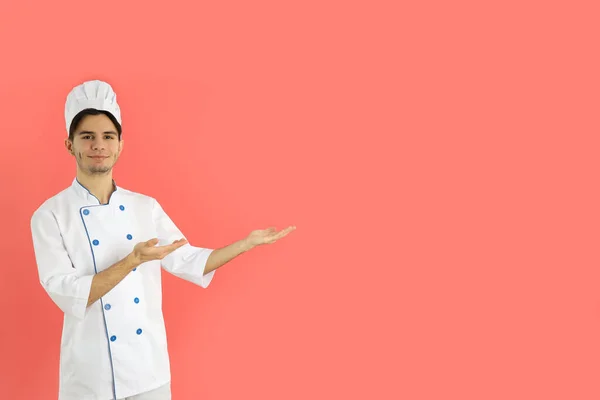 Concept Cooking Young Man Chef Pink Background — Stockfoto