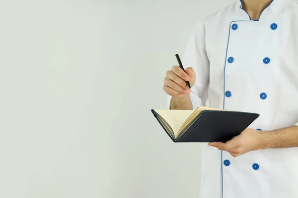 Joven Chef Masculino Con Libro Recetas Sobre Fondo Claro — Foto de Stock