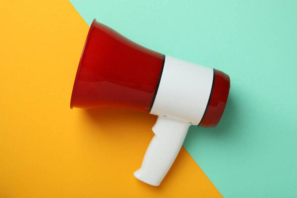 Red and white megaphone on two tone background