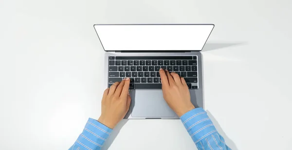Female hands and laptop on white background